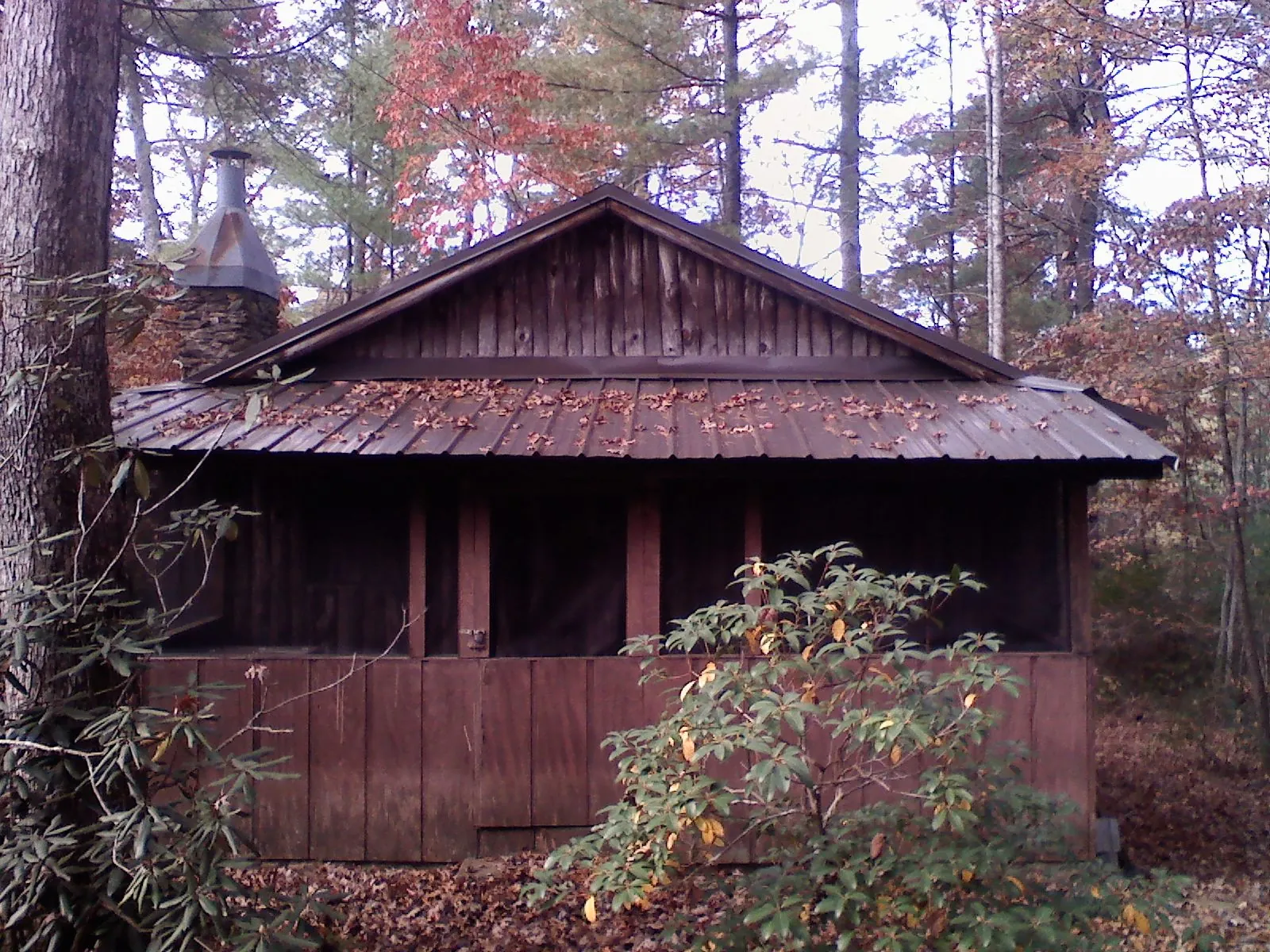 Metal roof over the screened porch of a rustic cabin in Elk Point