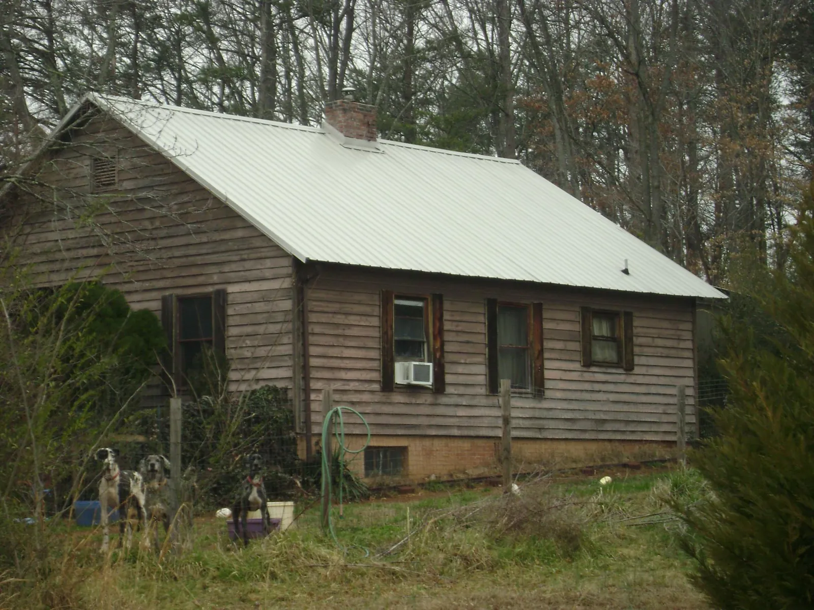 White metal roof on an old wood sided farmhouse, from a Metal Roof Installation job in Elk Point